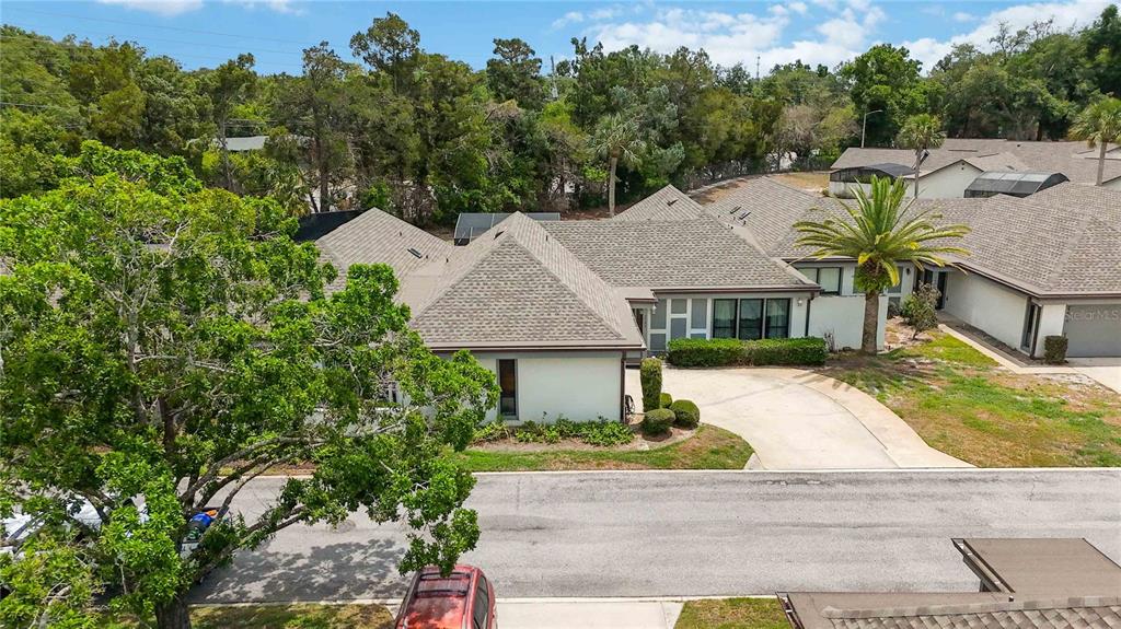 An aerial view shows a residential building with a shingled roof and a paved driveway — 1489 MAGELLAN CIRCLE UNIT 603, ORLANDO, FL