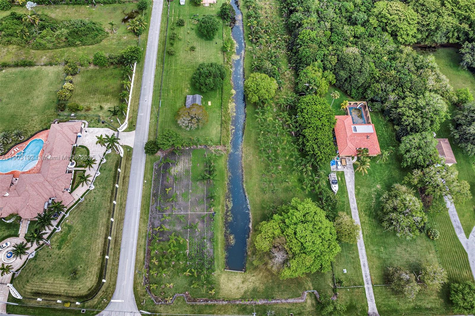 An aerial view shows two houses with swimming pools separated by a narrow canal — 178 Sw Ave, Southwest Ranches FL 33331, SOUTHWEST RANCHES, FL