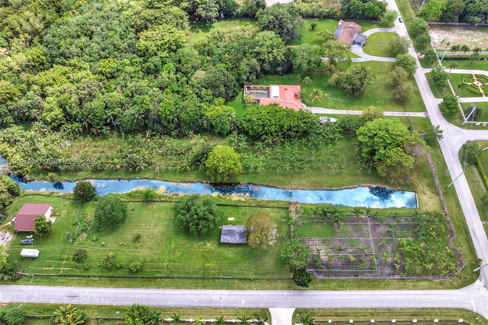 An aerial view shows a residential property with a canal, lush trees, and multiple buildings — 178 Sw Ave, Southwest Ranches FL 33331, SOUTHWEST RANCHES, FL