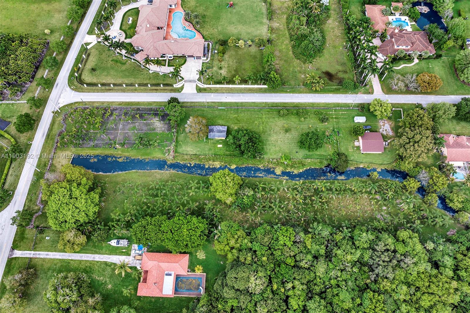An aerial view shows multiple residential properties with pools, lawns, and a canal — 178 Sw Ave, Southwest Ranches FL 33331, SOUTHWEST RANCHES, FL