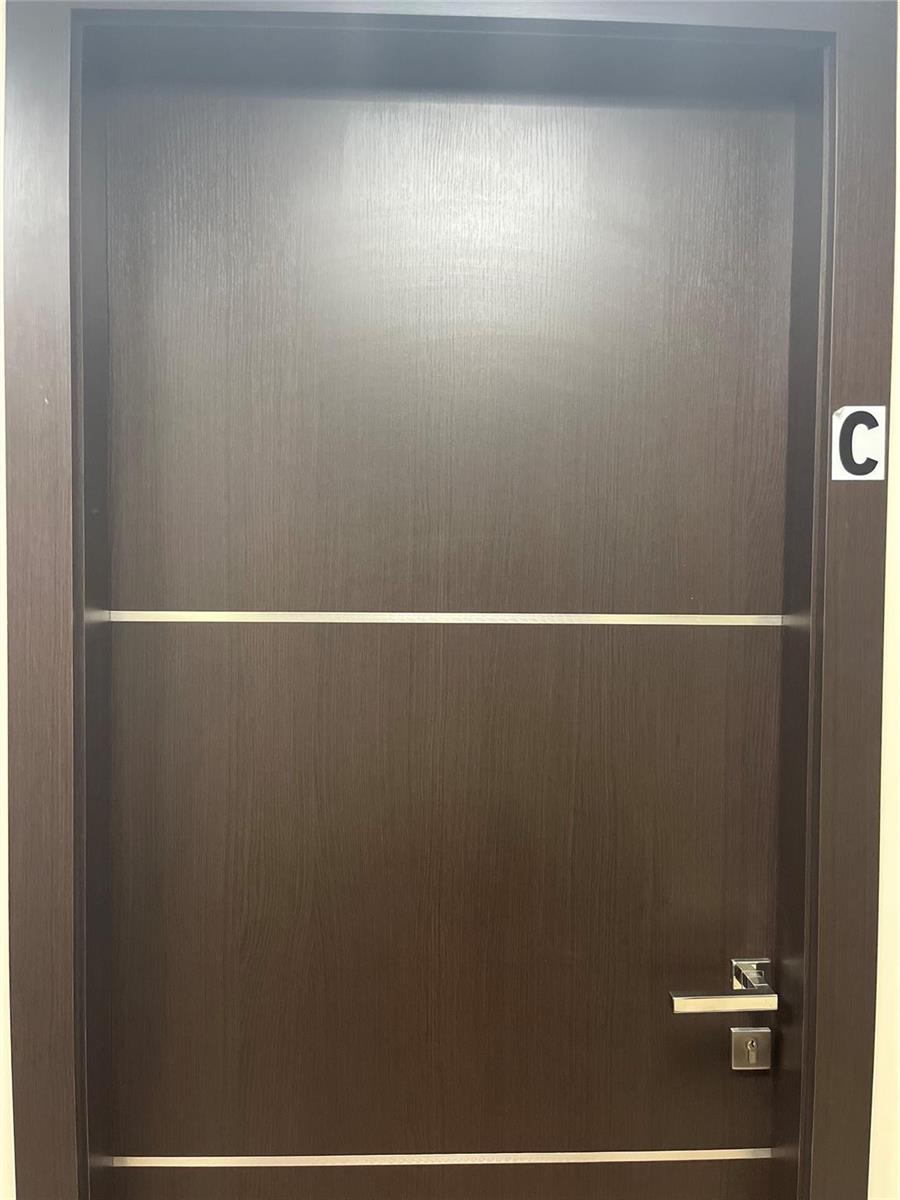 A dark wood-grain interior door features a horizontal silver inlay and a letter C label — 2730 SW 3rd Avenue # 202C, Miami FL 33129, MIAMI, FL