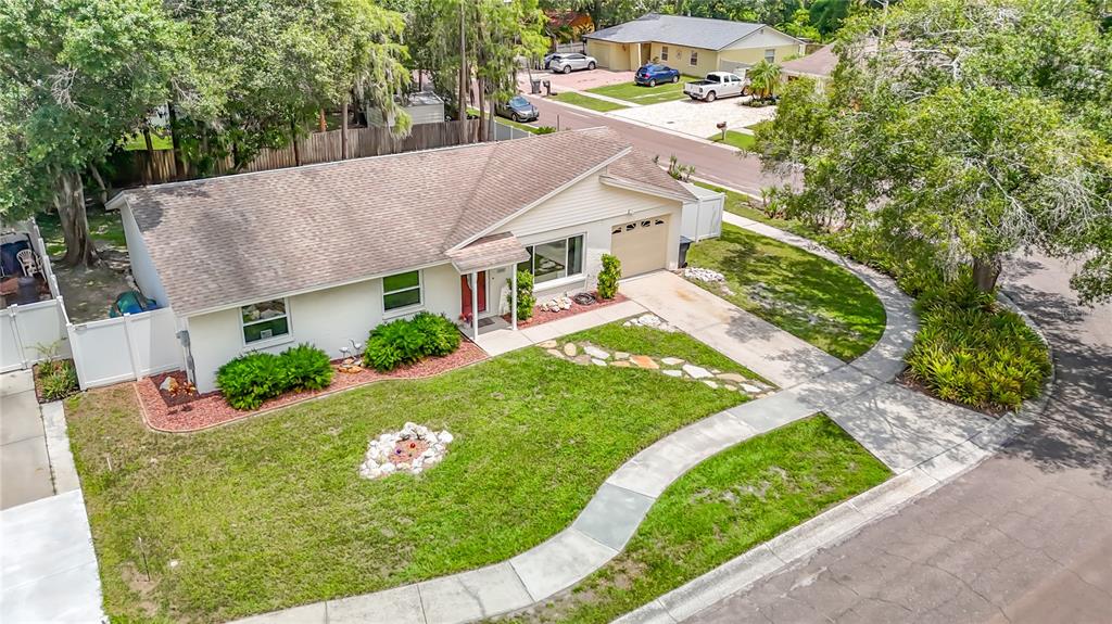 An aerial view of a single-story house with a tan roof, beige siding, and lawn — 11007 AIRVIEW DRIVE, TAMPA, FL