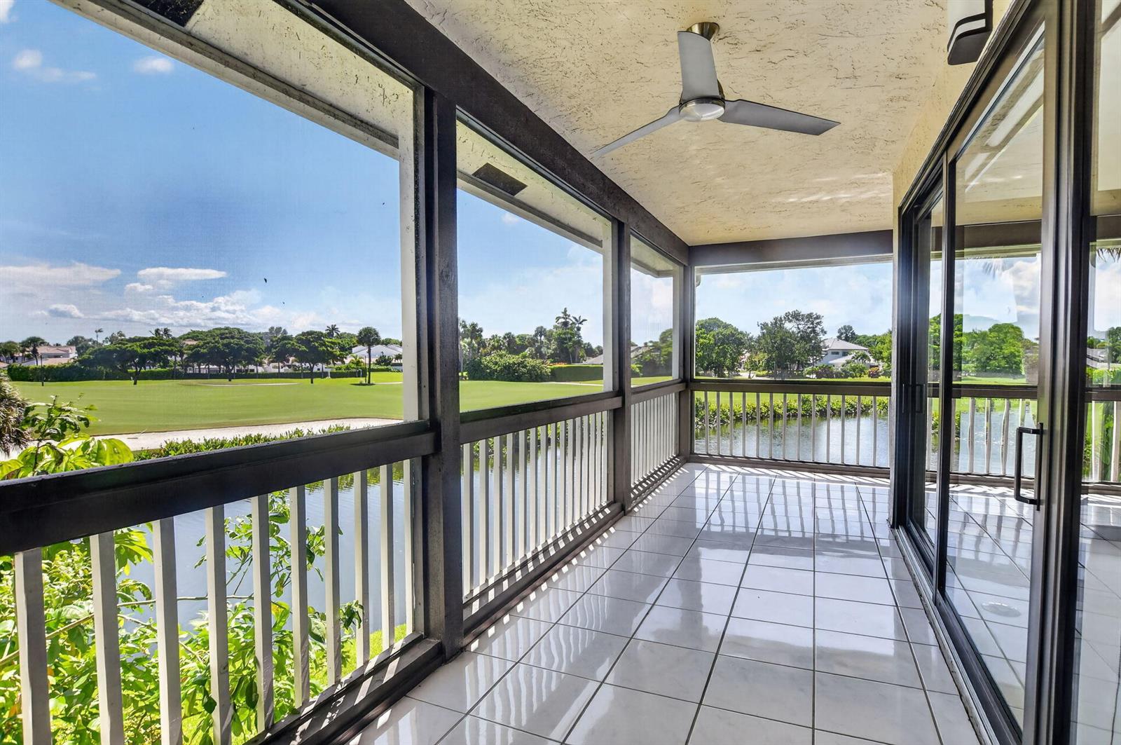 A tiled, screened-in balcony overlooks a pond and a golf course — 19317 Sabal Lake Drive # 5066, Boca Raton FL 33434, BOCA RATON, FL