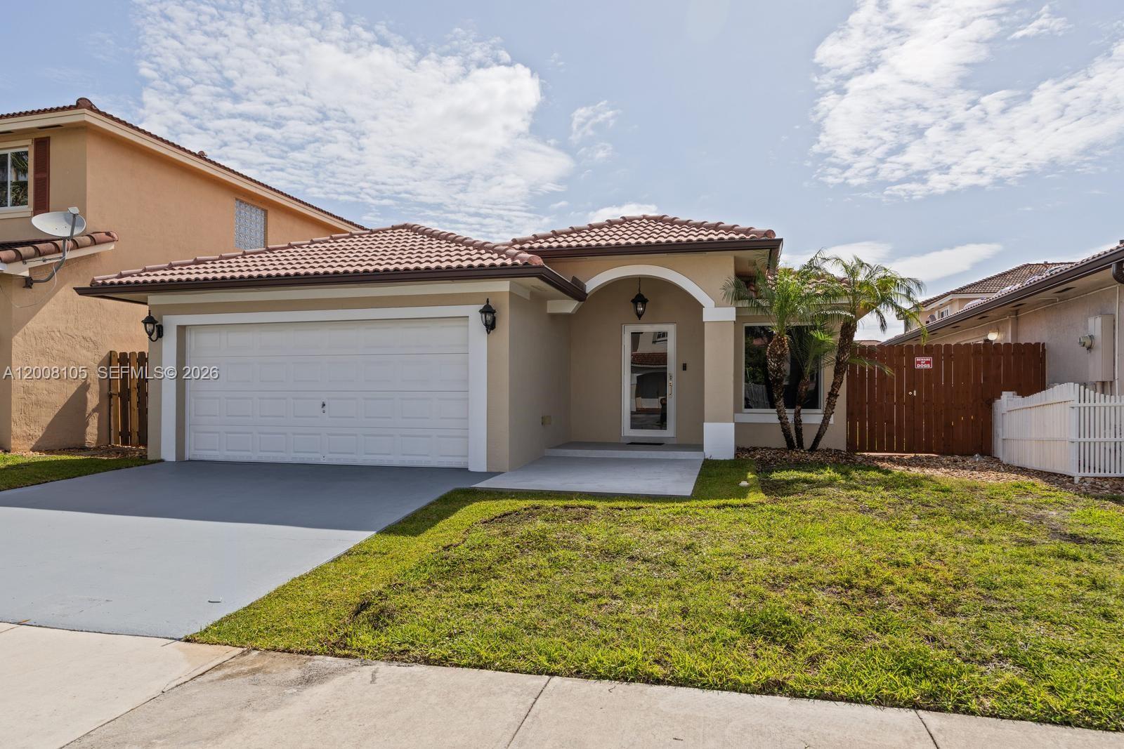 A single-story house with a beige stucco exterior, a tile roof, and a two-car garage — 21505 SW 89th Path, Cutler Bay FL 33189, CUTLER BAY, FL