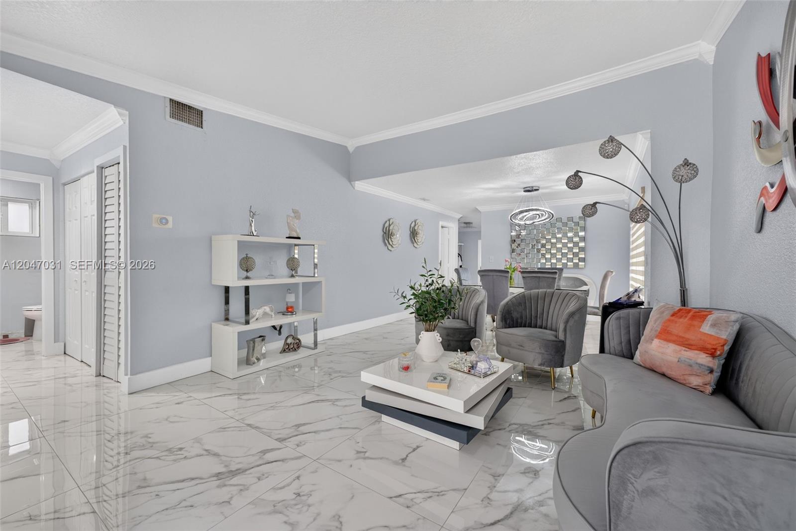 A living room features light gray walls, marble-patterned tile flooring, and modern velvet furniture — 1635 SW 138th Ct, Miami FL 33175, MIAMI, FL