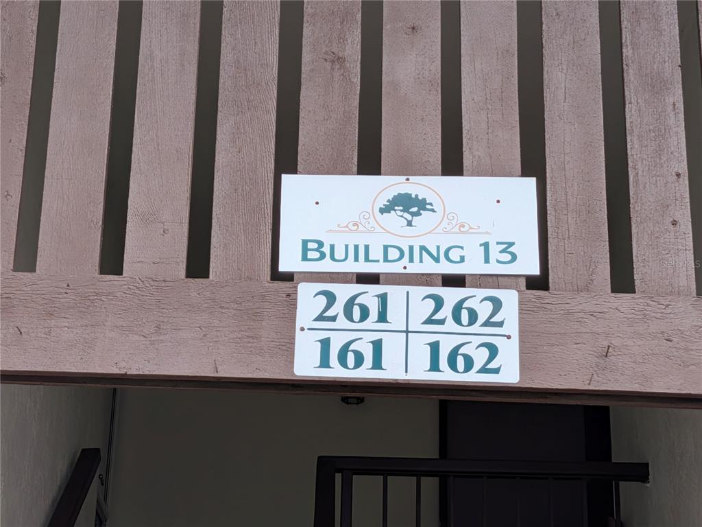 A sign for Building 13 displays unit numbers 161, 162, 261, and 262 — 2400 FOREST DRIVE UNIT 261, INVERNESS, FL