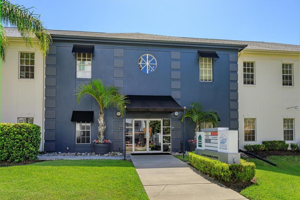 The exterior of a two-story office building with a blue facade and a central entrance — 11 N SUMMERLIN AVENUE UNIT 100, ORLANDO, FL
