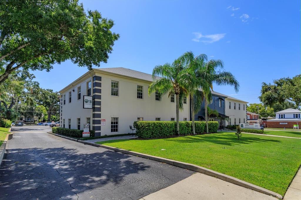 A two-story commercial building with a paved driveway, palm trees, and a manicured lawn — 11 N SUMMERLIN AVENUE UNIT 100, ORLANDO, FL