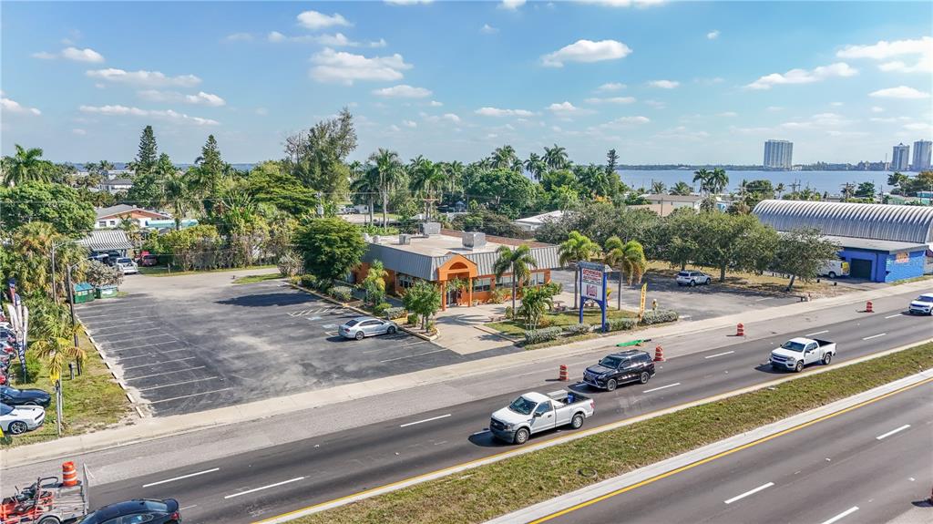 An aerial view shows a commercial building with a parking lot next to a highway — 1130 N TAMIAMI TRAIL, NORTH FORT MYERS, FL