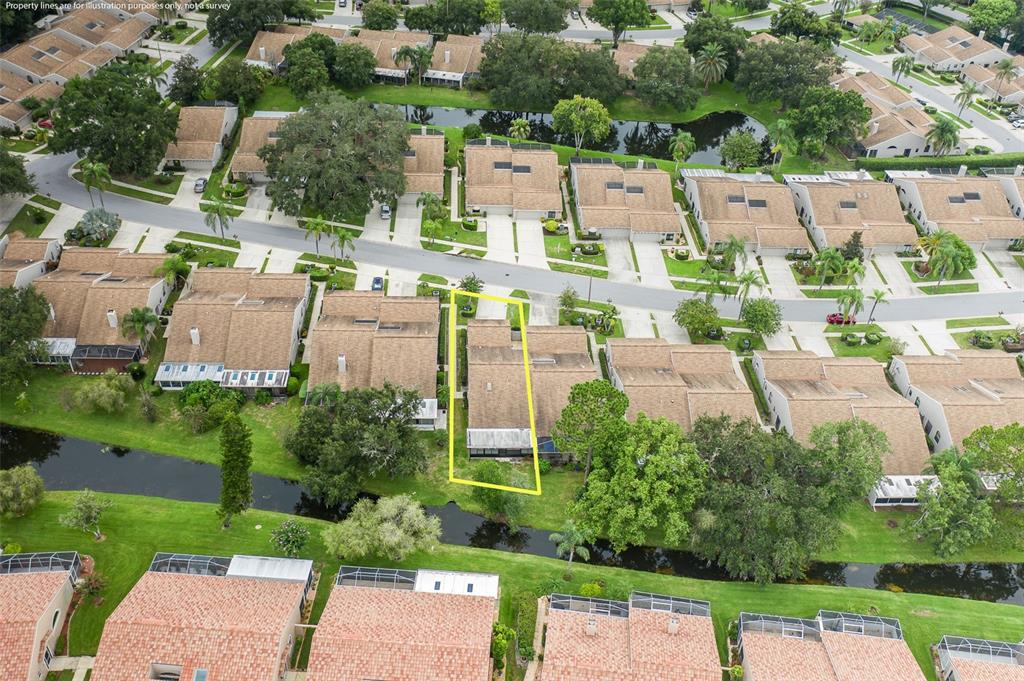 An aerial view shows a residential townhouse highlighted in yellow, situated along a small canal — 5508 SALEM SQUARE DRIVE S, PALM HARBOR, FL
