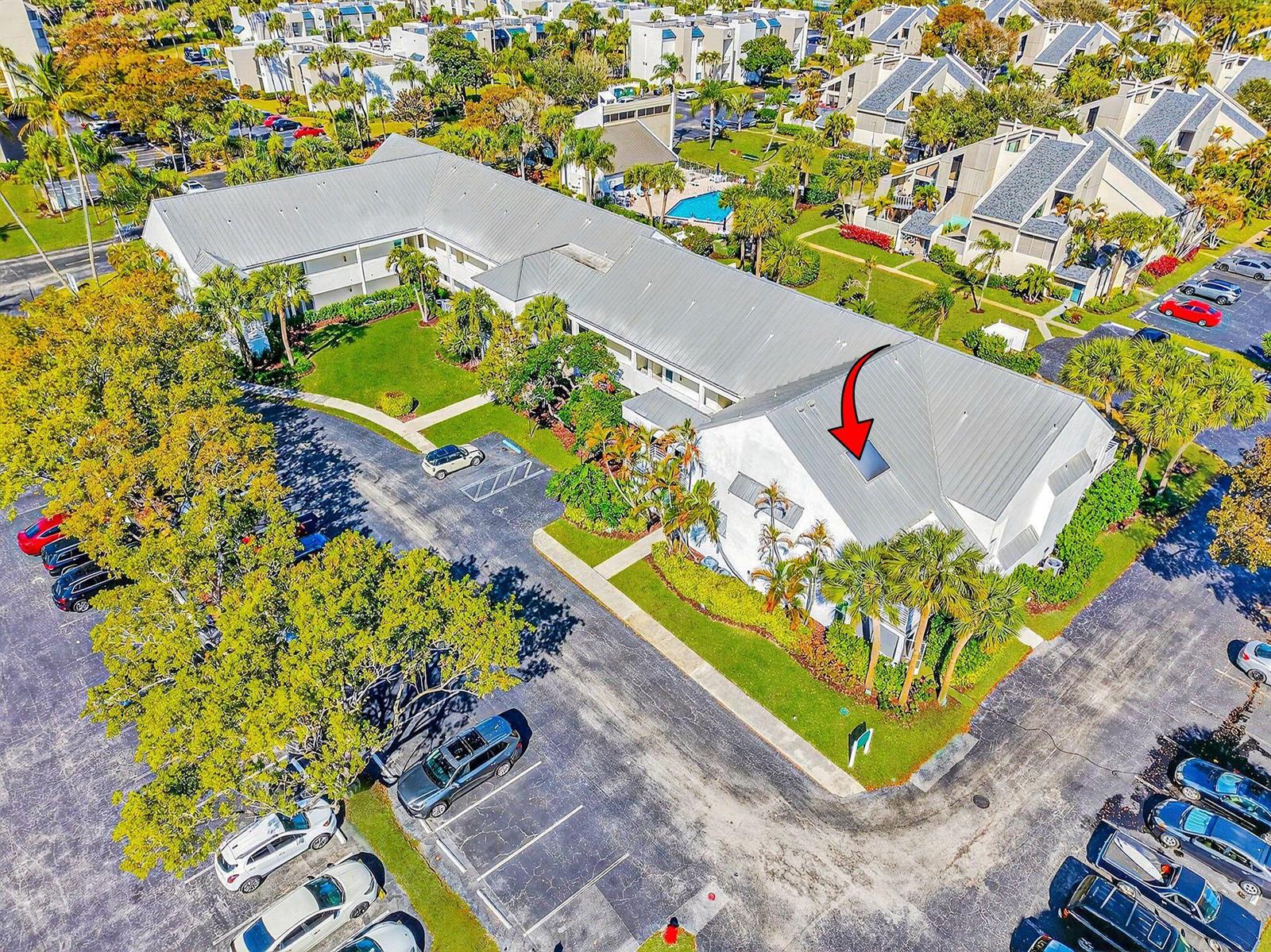 An aerial view of a multi-story residential building with a metal roof and parking lot — 1605 S Us Highway 1 # 215, Jupiter FL 33477, JUPITER, FL