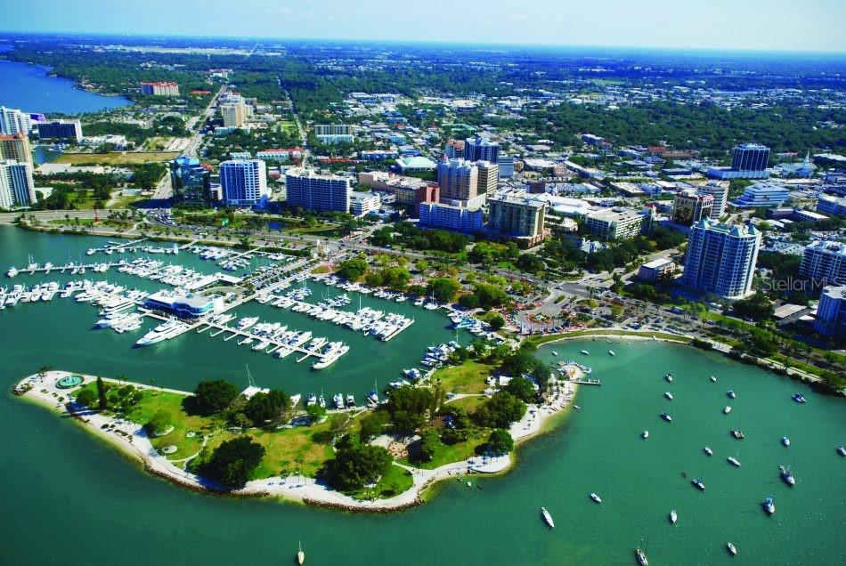 An aerial view of a marina, a park, and a city skyline along a waterfront — 771 JOHN RINGLING BOULEVARD UNIT 3, SARASOTA, FL