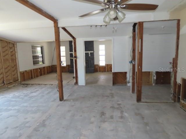 An interior view of a house under renovation with exposed wall studs and concrete floors — 6060 62ND STREET N, ST PETERSBURG, FL
