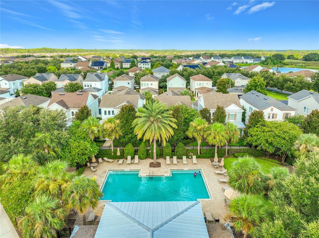 An aerial view of a community swimming pool surrounded by lounge chairs and residential homes — 7222 STILL POND LANE, WINDERMERE, FL