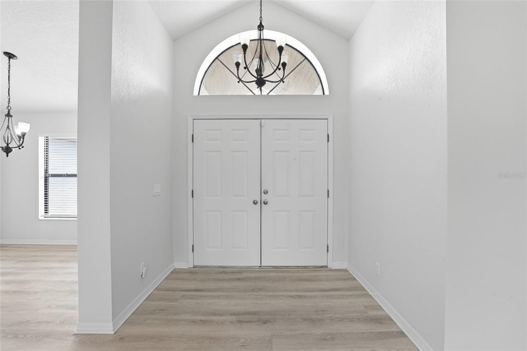 An aerial view shows a single-story house with a brown roof and a circular driveway — 26070 DOLMAN COURT, PUNTA GORDA, FL