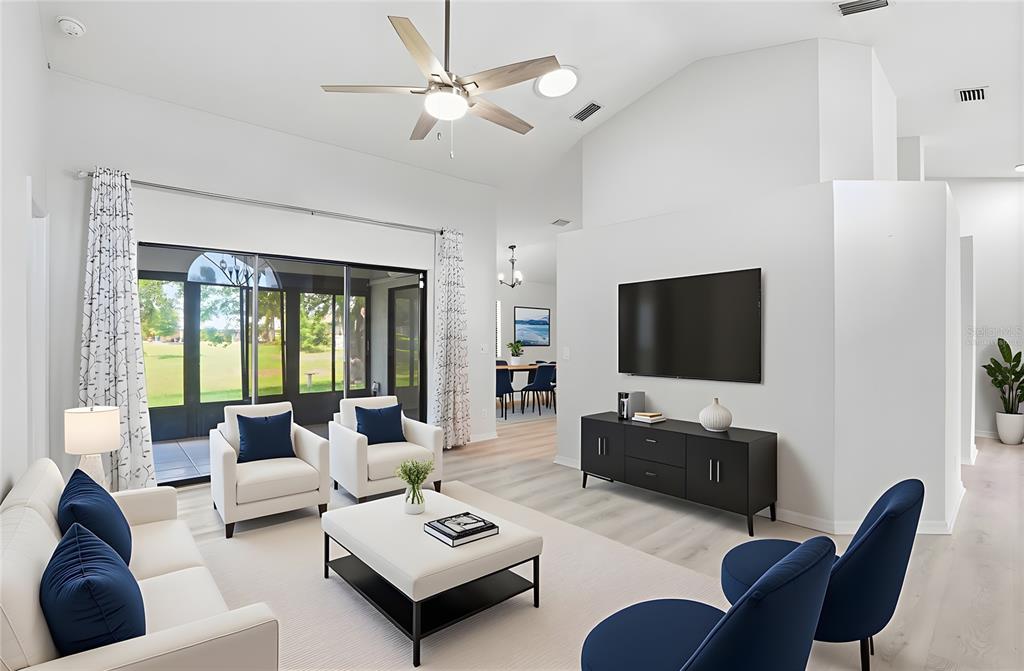 An entryway features white double doors, a vaulted ceiling, and light wood-look flooring — 26070 DOLMAN COURT, PUNTA GORDA, FL