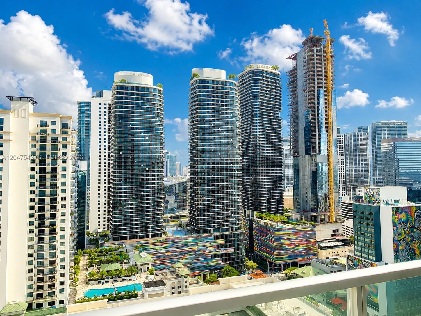 An elevated view of several modern high-rise apartment buildings and a construction site in Miami — MIAMI, FL