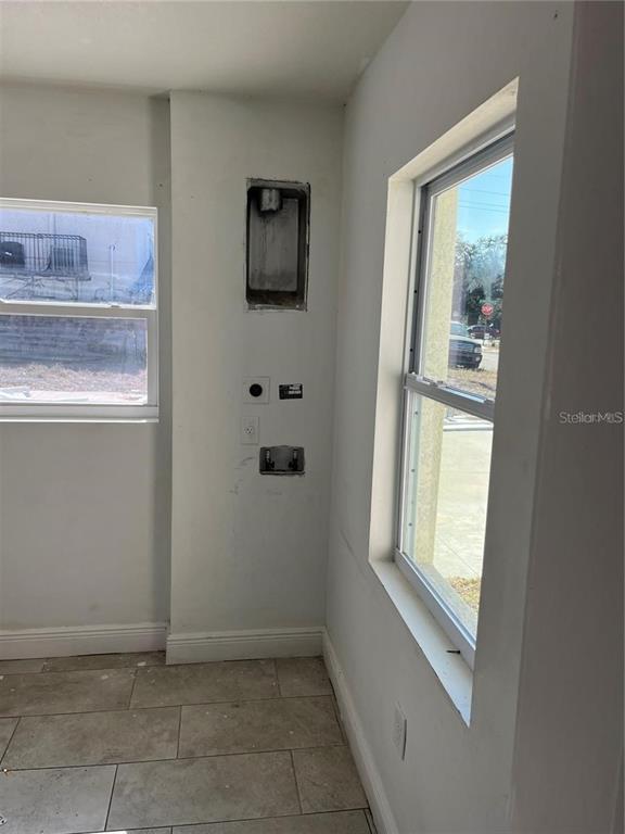 A laundry area features a wall-mounted dryer vent, water hookups, and tile flooring — 3301 E IDA STREET, TAMPA, FL