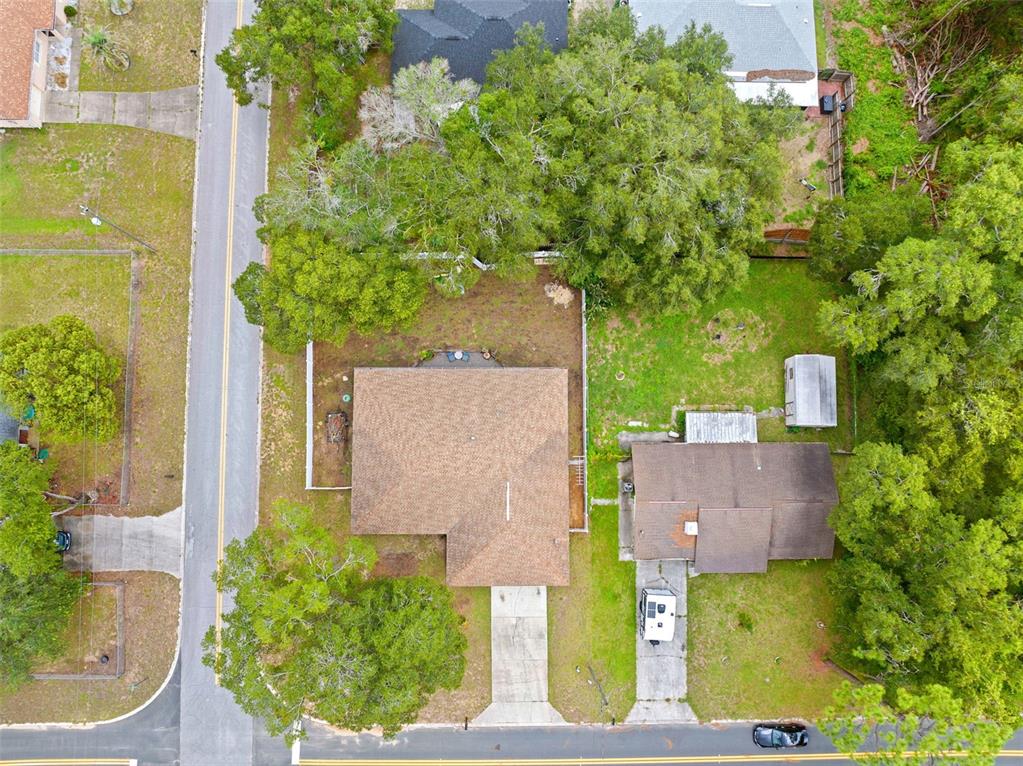 An aerial view shows two adjacent houses with driveways, lawns, and surrounding trees — 714 SPRUCE STREET, INVERNESS, FL