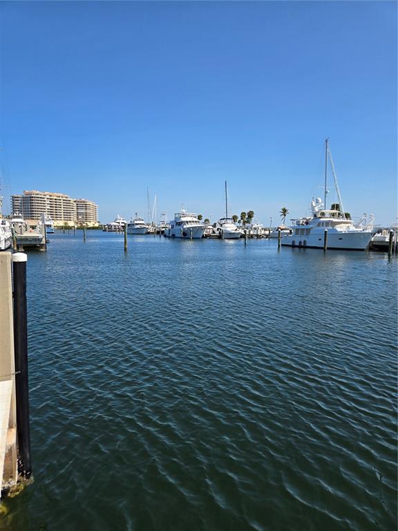 A marina with several yachts docked in the water under a clear blue sky — 2800 HARBOURSIDE DRIVE UNIT F-06, LONGBOAT KEY, FL