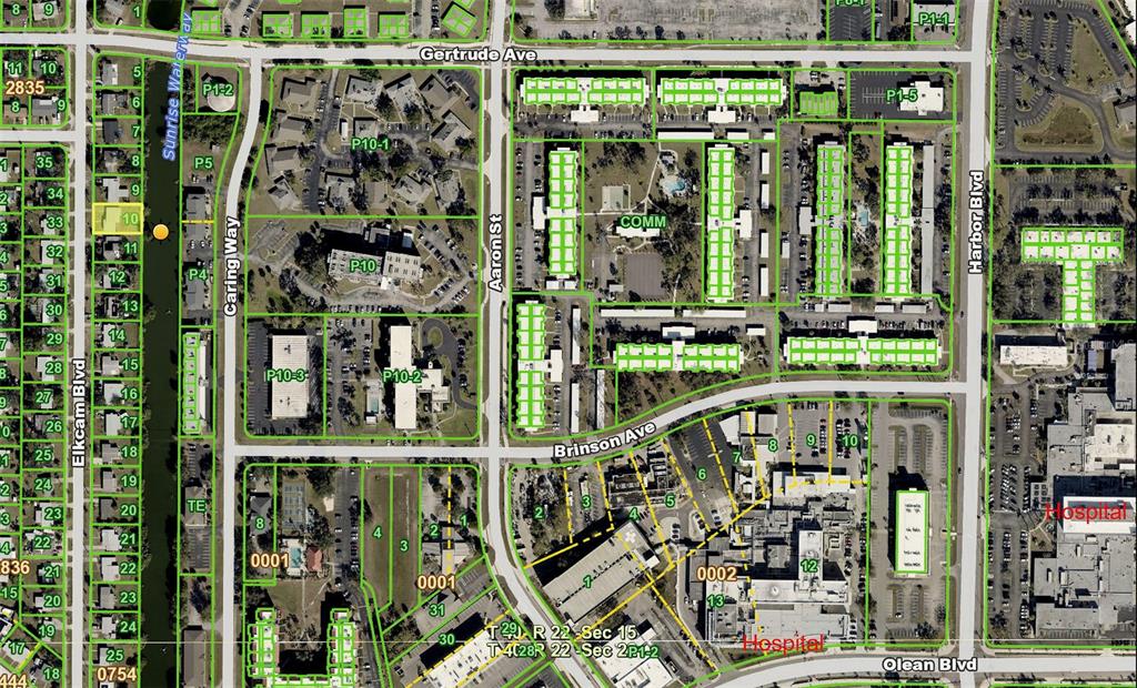 This is an aerial map showing residential and commercial properties near a hospital — 2440 ELKCAM BOULEVARD, PORT CHARLOTTE, FL