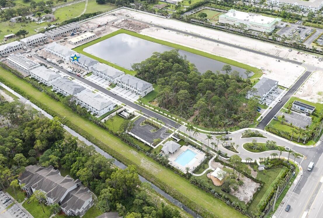 Aerial view of a residential townhouse community with a central pond and swimming pool — 4238 Efendi Drive # 30, Lantana FL 33462, LANTANA, FL