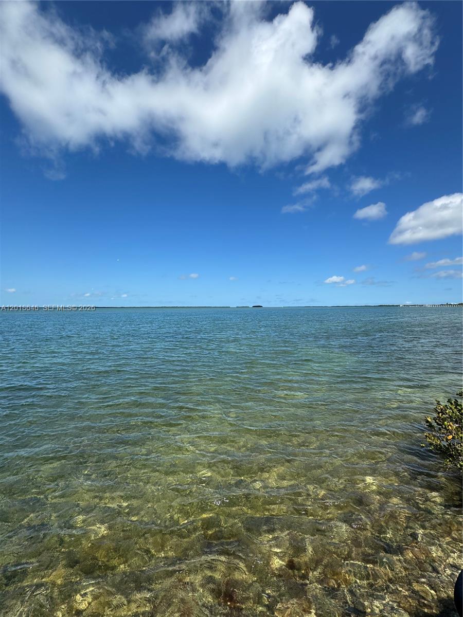 A view of clear, shallow water under a bright blue sky with scattered clouds — Lot 27 Dorn Road, Torch Key FL 33042, TORCH KEY, FL