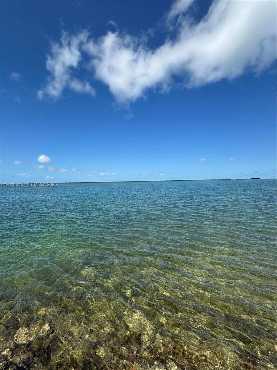 A view of clear, shallow water meeting the horizon under a bright blue sky — Lot 27 Dorn Road, Torch Key FL 33042, TORCH KEY, FL