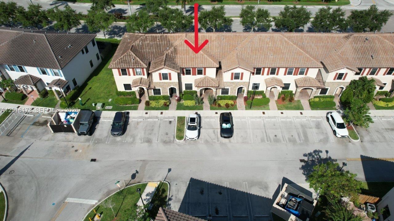 An aerial view shows a row of townhouses with tiled roofs and a parking lot — 11540 SW 151st Ave, Miami FL 33196, MIAMI, FL