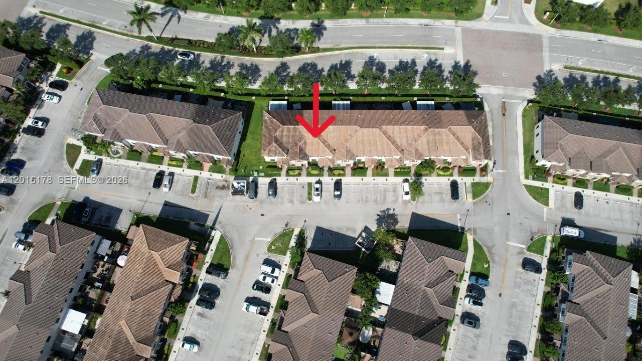 An aerial view shows a residential townhouse complex with a red arrow pointing to a unit — 11540 SW 151st Ave, Miami FL 33196, MIAMI, FL