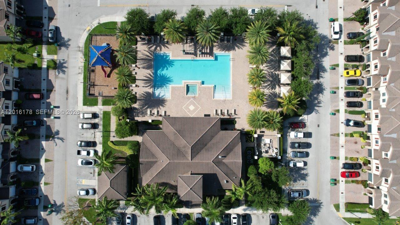 An aerial view shows a community swimming pool, playground, clubhouse, and surrounding parking areas — 11540 SW 151st Ave, Miami FL 33196, MIAMI, FL