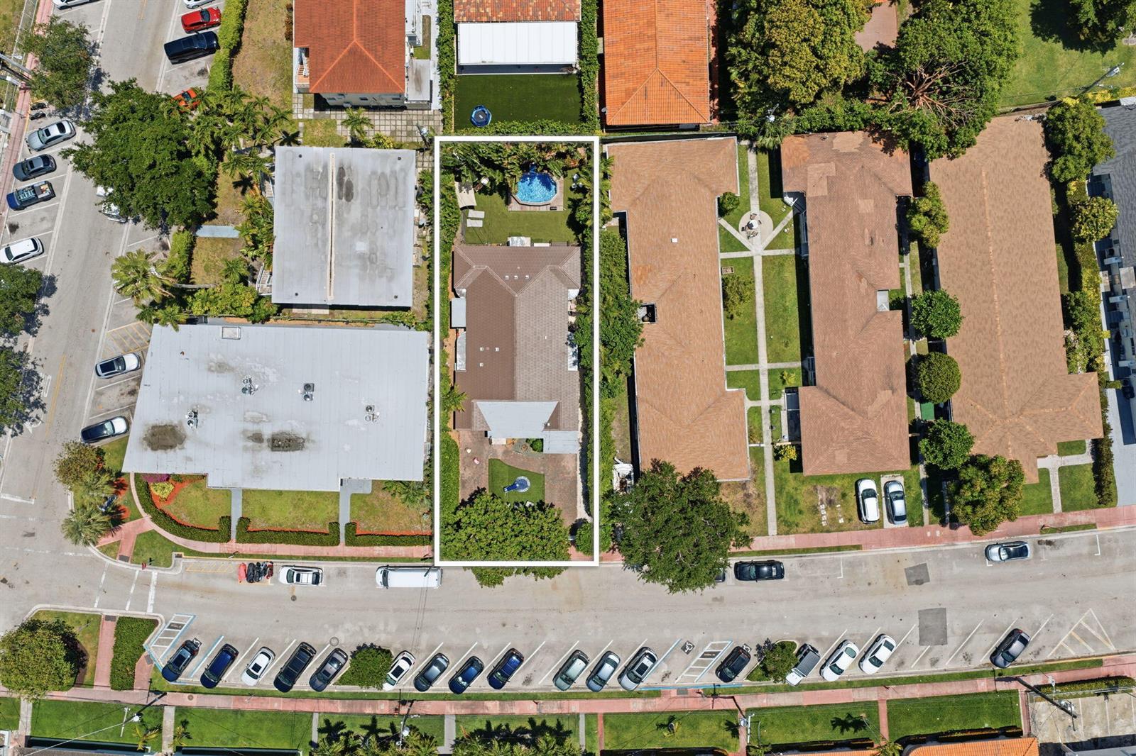 An aerial view shows a residential property with a pool, backyard, and surrounding neighborhood buildings — 2183 Bay Drive, Miami Beach FL 33141, MIAMI BEACH, FL