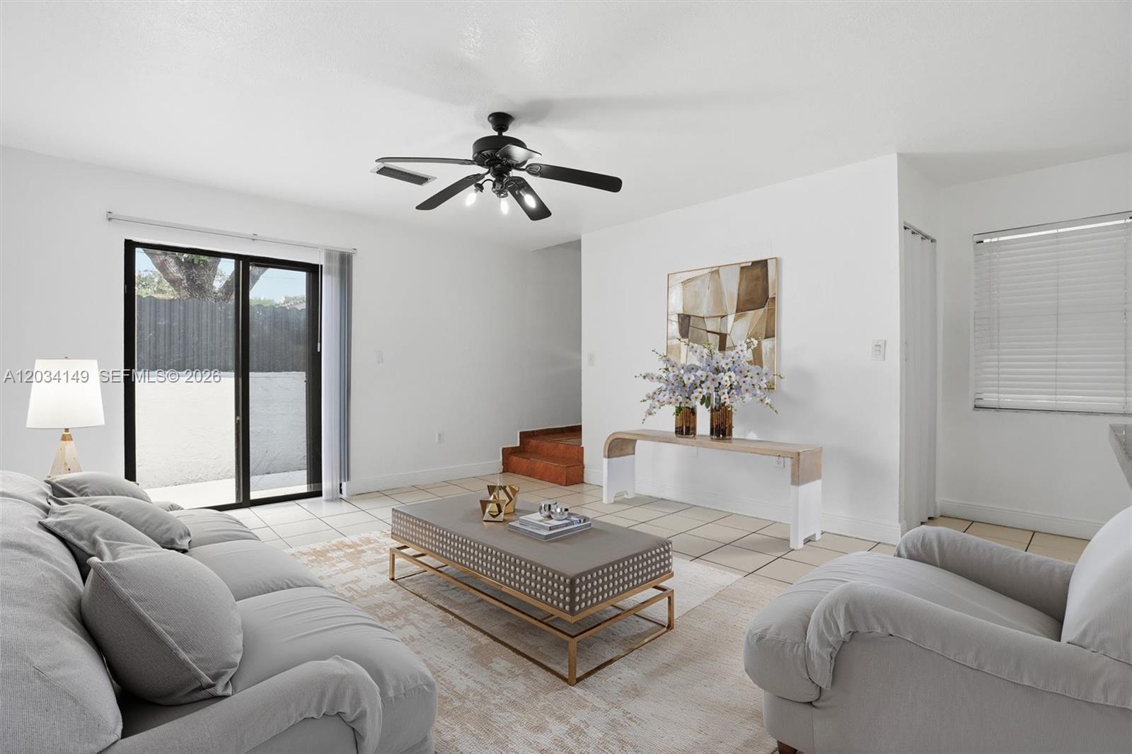A living room features light tile floors, a gray sofa, and a central coffee table — 1389 NW 31st Ave # B, Miami FL 33125, MIAMI, FL