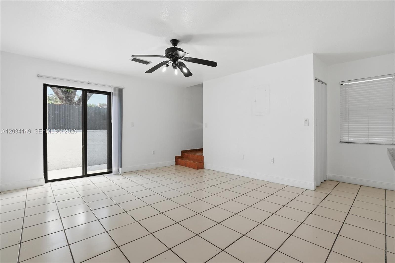 A room with white walls, light-colored floor tiles, a ceiling fan, and sliding glass doors — 1389 NW 31st Ave # B, Miami FL 33125, MIAMI, FL