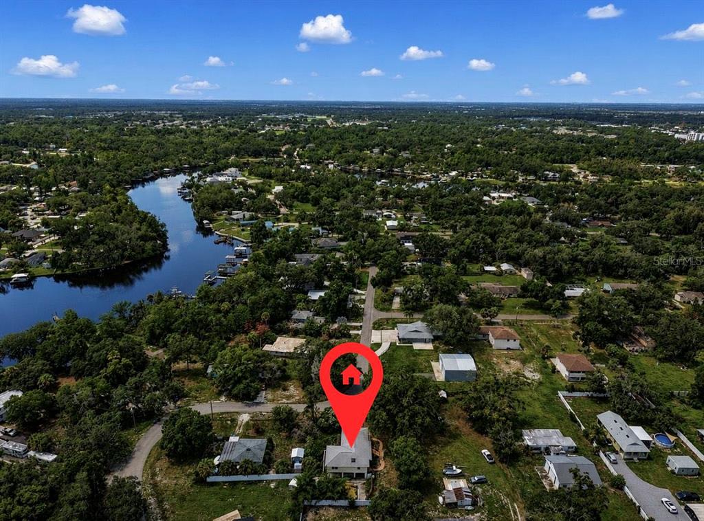 An aerial view shows a house with a red location pin in a wooded neighborhood — 8017 MAYS AVENUE, RIVERVIEW, FL