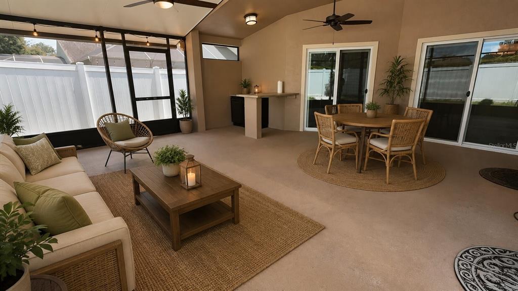 A covered outdoor patio features a seating area, a dining set, and a built-in bar — 649 BUCKINGHAM DRIVE, OVIEDO, FL