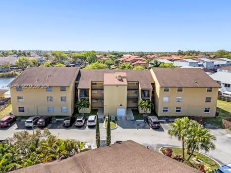 An aerial view shows a three-story apartment building with a brown roof and parking lot — 15430 SW 82nd Ln # 625, Miami FL 33193, MIAMI, FL