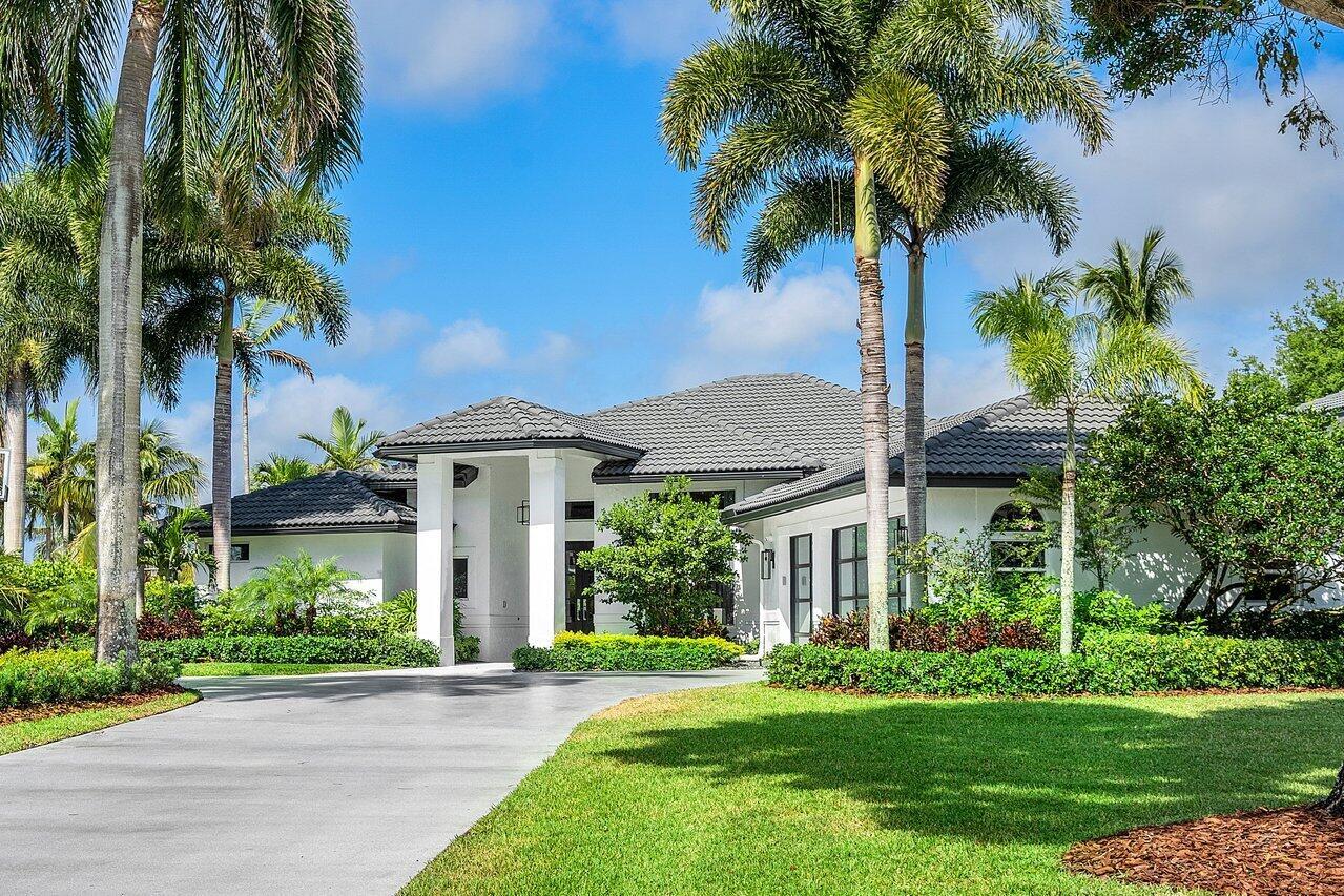A white single-story house with a gray tile roof and palm trees in the front yard — 8331 Sawpine Road, Delray Beach FL 33446, DELRAY BEACH, FL