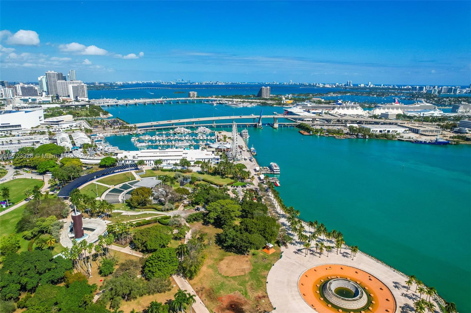 An aerial view of a waterfront park with a large circular plaza and city skyline — 50 Biscayne Blvd # 4208, Miami FL 33132, MIAMI, FL