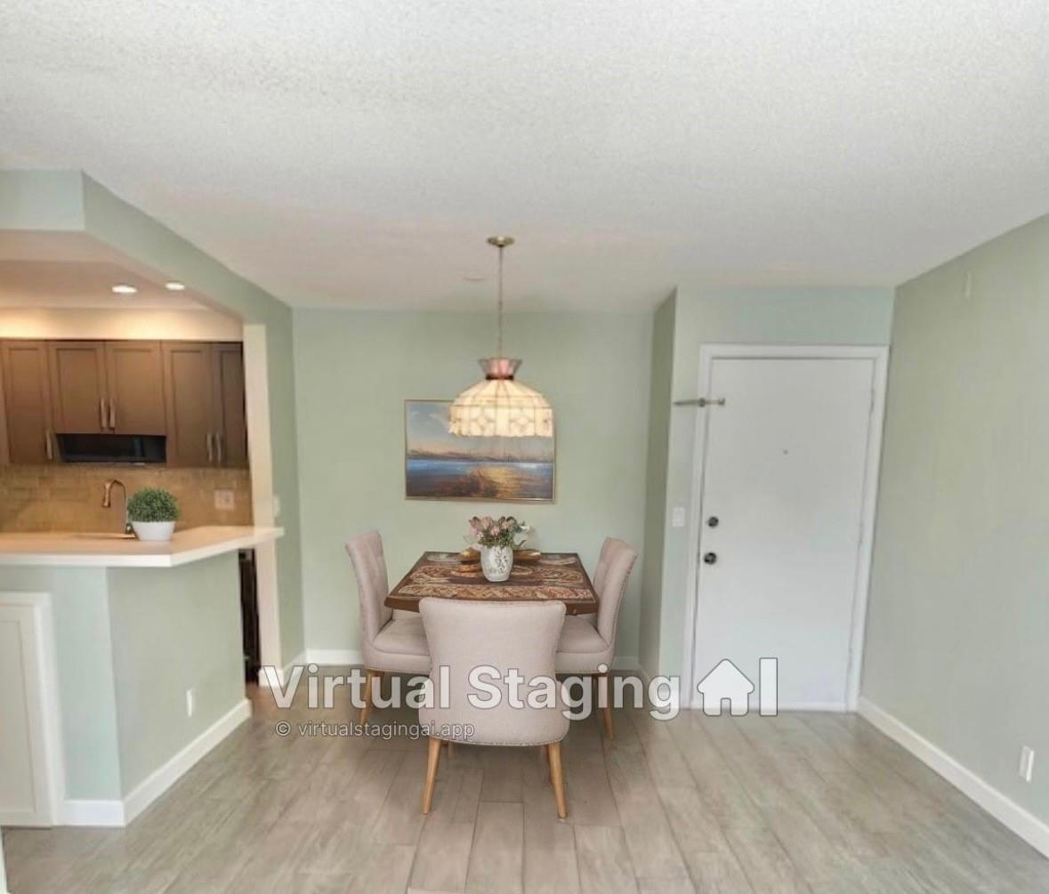 This is a virtually staged dining area with light green walls and wood-look flooring — 130 Cypress Club Drive Apt 323, Pompano Beach FL 33060, POMPANO BEACH, FL
