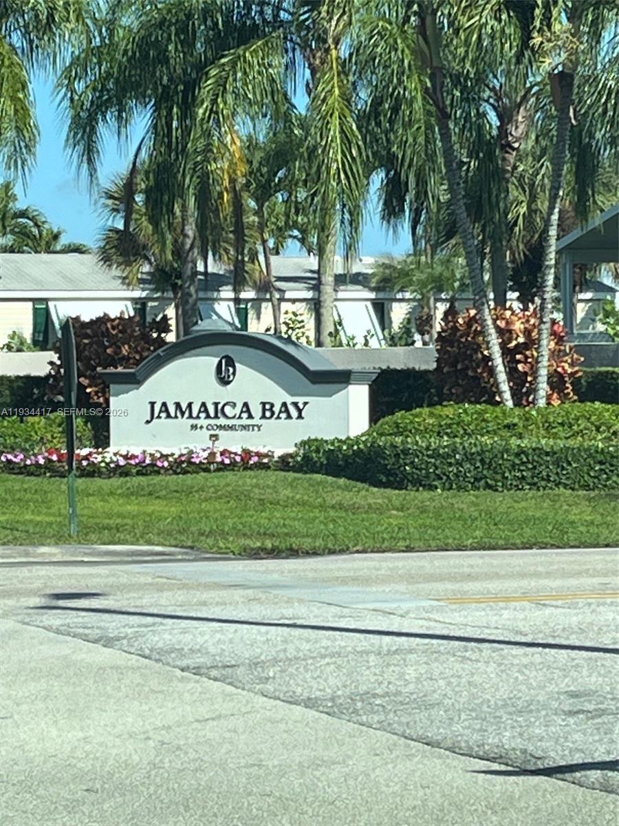 A sign for the Jamaica Bay 55+ community stands in front of palm trees and landscaping — 56007 Amparo Bay, Boynton Beach FL 33436, BOYNTON BEACH, FL