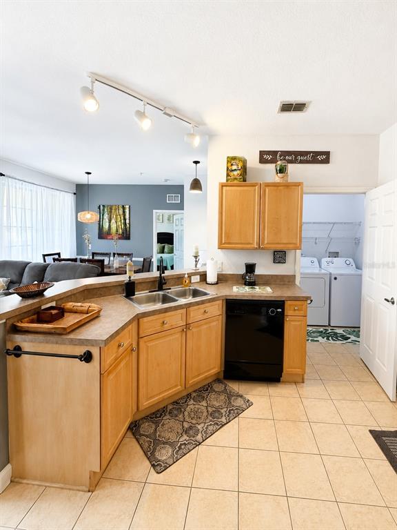 A kitchen with light wood cabinets, a black dishwasher, and a tiled floor — 313 TERRACE RIDGE CIRCLE UNIT 313, DAVENPORT, FL