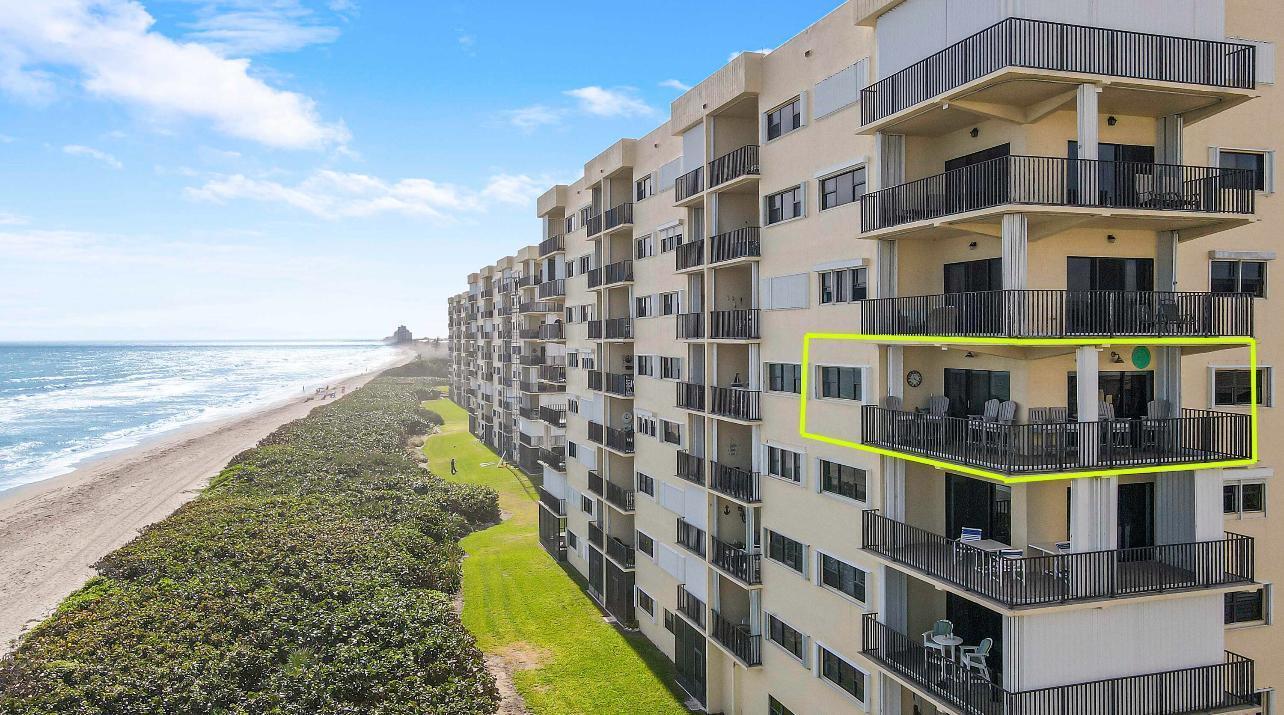 An aerial view of a beachfront condominium building with a highlighted balcony overlooking the ocean — 7410 S Ocean Drive # 505, Jensen Beach FL 34957, JENSEN BEACH, FL