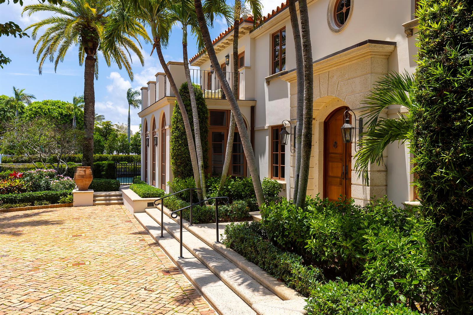 A Mediterranean-style home exterior features a brick driveway, palm trees, and a stone entryway — 614 Tarpon Way, Palm Beach FL 33480, PALM BEACH, FL