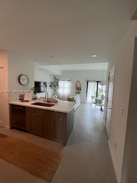 A kitchen island with a sink overlooks an open-concept living and dining area — 2526 Pierce st # 10, Hollywood FL 33020, HOLLYWOOD, FL