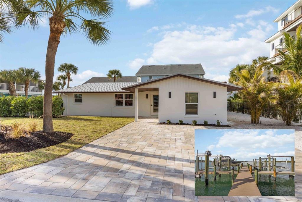 A white house with a paved driveway and an inset photo of a boat dock — 120 STANFORD DRIVE, ENGLEWOOD, FL