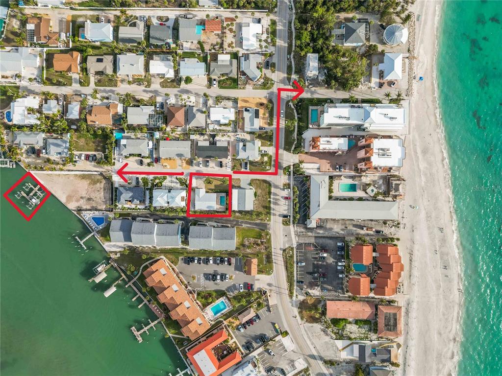An aerial view shows a coastal neighborhood with red outlines highlighting a house and dock — 120 STANFORD DRIVE, ENGLEWOOD, FL