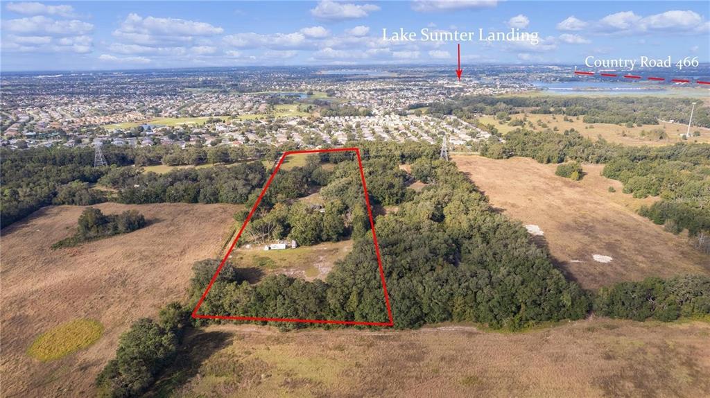 An aerial view shows a rectangular plot of land outlined in red amidst rural fields — 38020 CHERRY LAKE ROAD, FRUITLAND PARK, FL