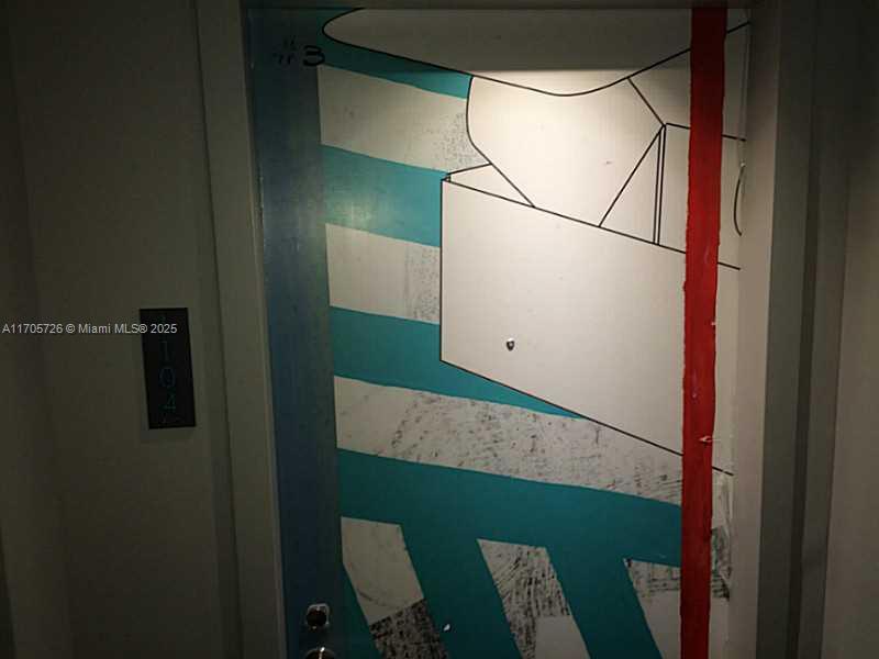 A painted apartment door with blue stripes and a red vertical line in a hallway — 4250 Biscayne Blvd # 1104, Miami FL 33137, MIAMI, FL