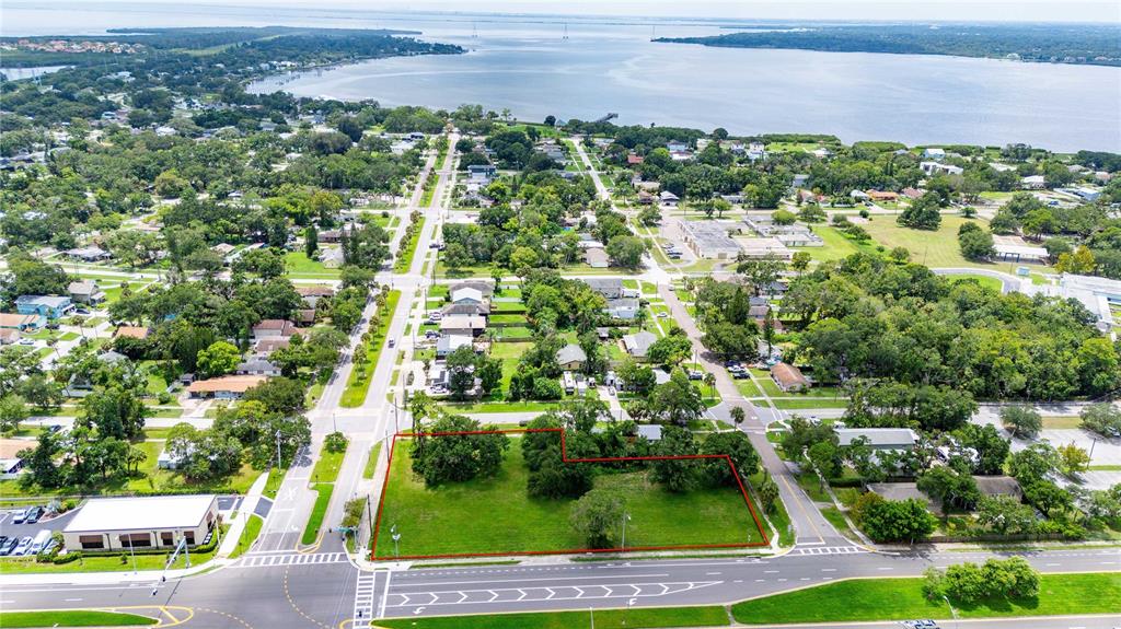 An aerial view shows a vacant, rectangular lot outlined in red near a waterfront area — 205 CHESTNUT STREET, OLDSMAR, FL